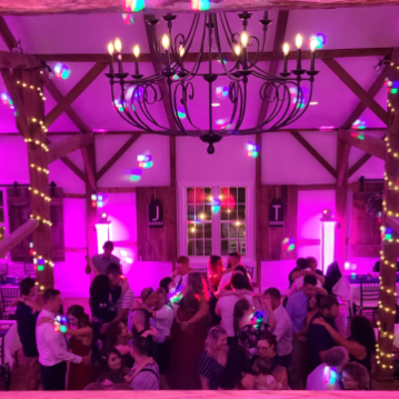 Photo of crowd dancing at a wedding with up lighting at Osbornia Farm Wedding and Event Venue Quarryville PA