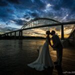 Photo of the couple at Sun down in front of the Chesapeake City Bridge at Shaffer's Canal house. 