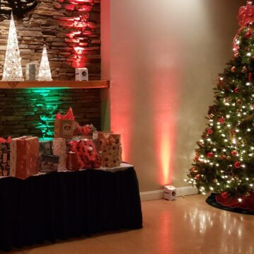 DJ Lighting at a Christmas event highlighting Fire place, Presents and Christmas tree at Middletown De