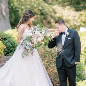 Photo as Jordan kisses Abby's hand at their wedding at Greenville Country Club Wilmington De